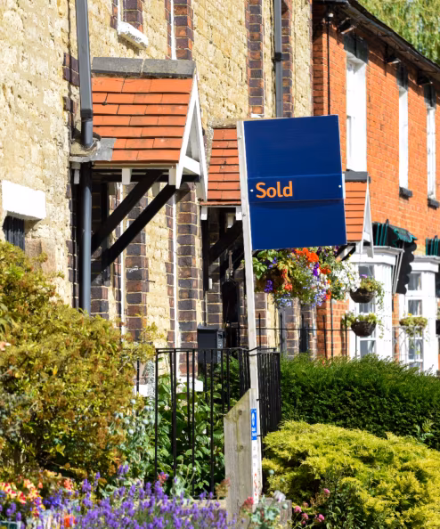 House for sale sign reading sold by estate agent or real estate letting